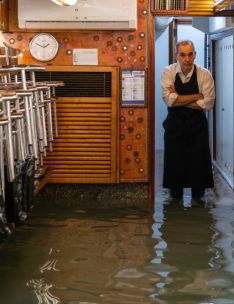 A red fire alarm switch with a warning sign on a concrete wall, highlighting safety in industrial settings.